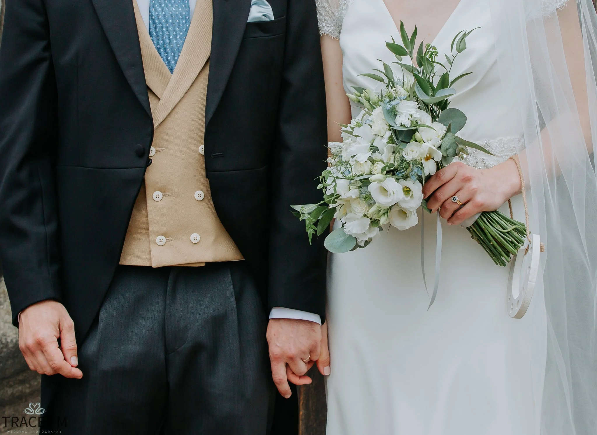 Bride and groom holding hands outside the church in Ticknall