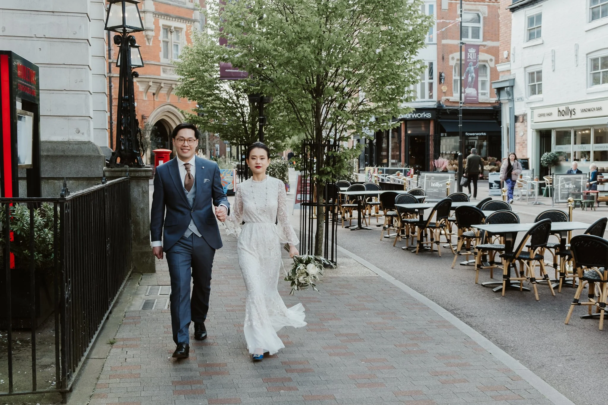 bride and groom walking in leicester city after their elopement ceremony at the town hall