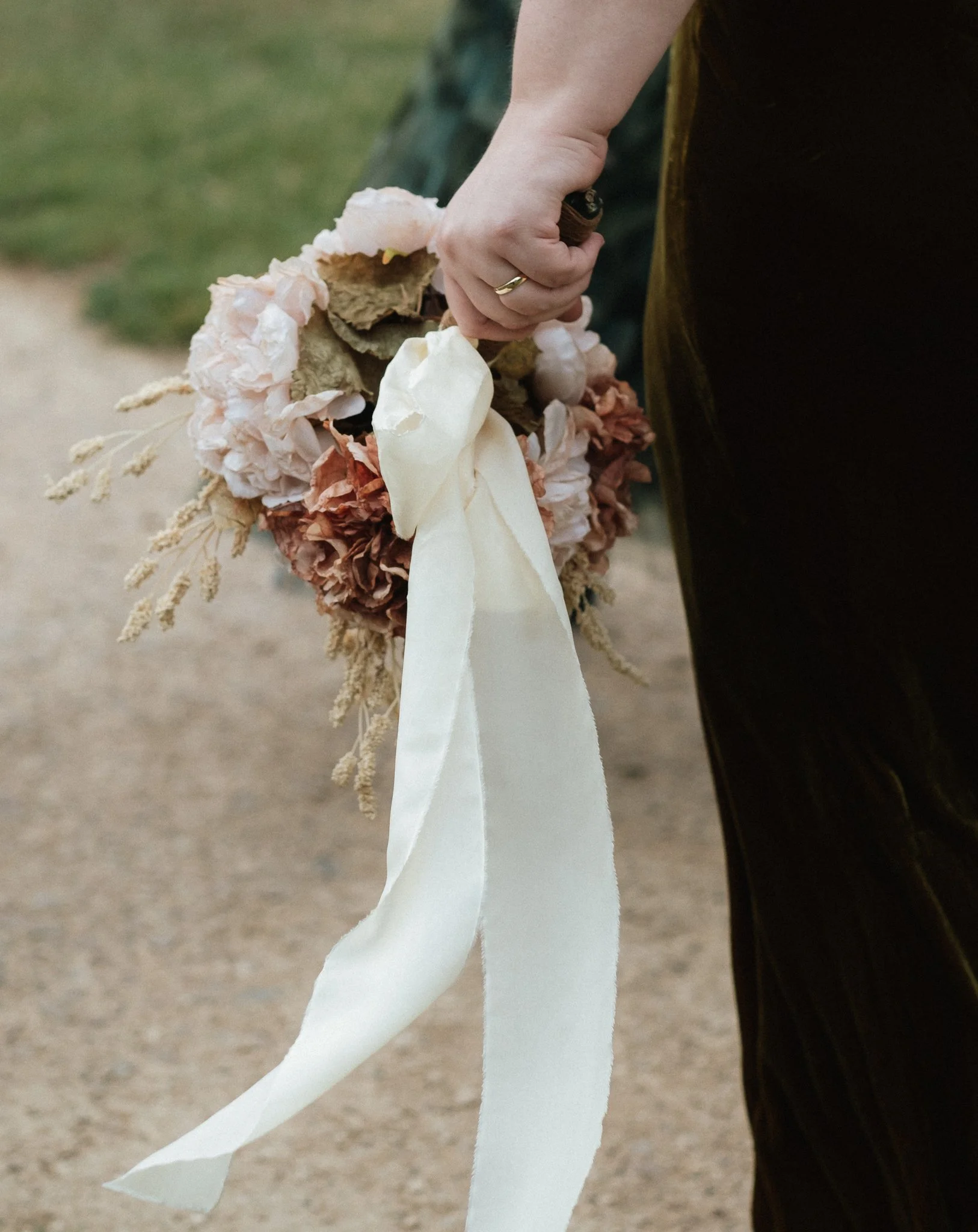 Wedding ring detail with hand made bouquet at Coalville Registry Office