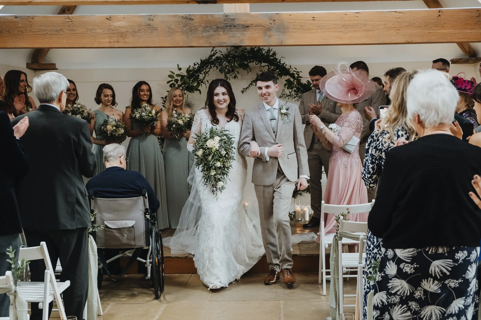 bride and groom walking down the aisle at Hanbury Barns