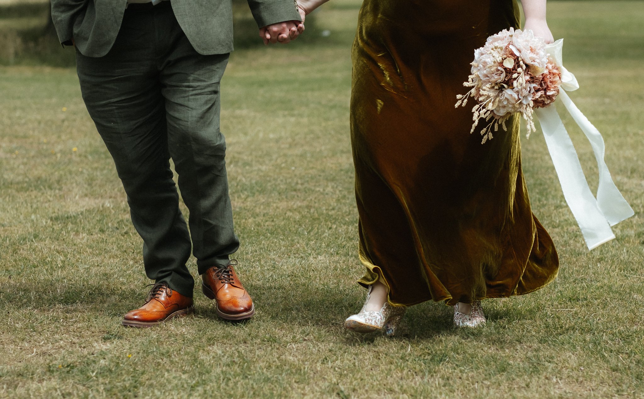 Wedding couple walking through Bosworth Park after registry office ceremony