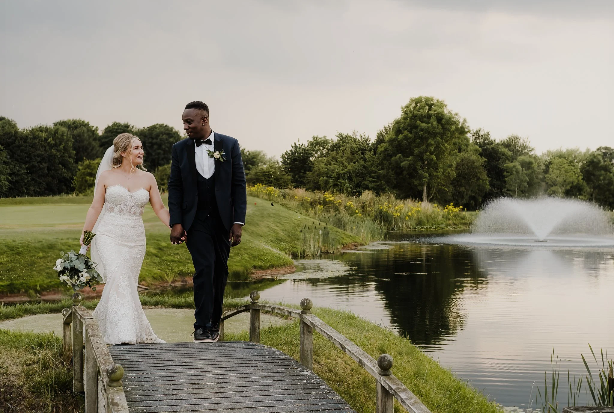 Bride and groom walking across the golf course at The Nottinghamshire Private Hire