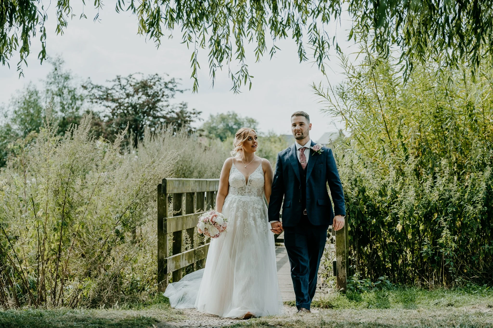 Couple walking hand in hand over a bridge at The Riverside Hotel in Branston, Burton on Trent