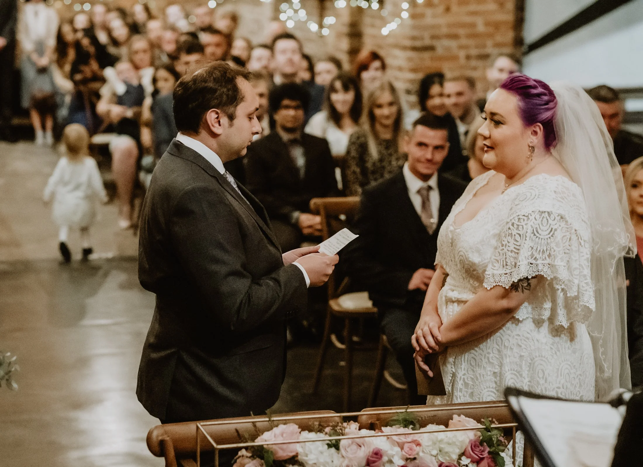 Bride and groom exchanging vows at Donington Park Farmhouse