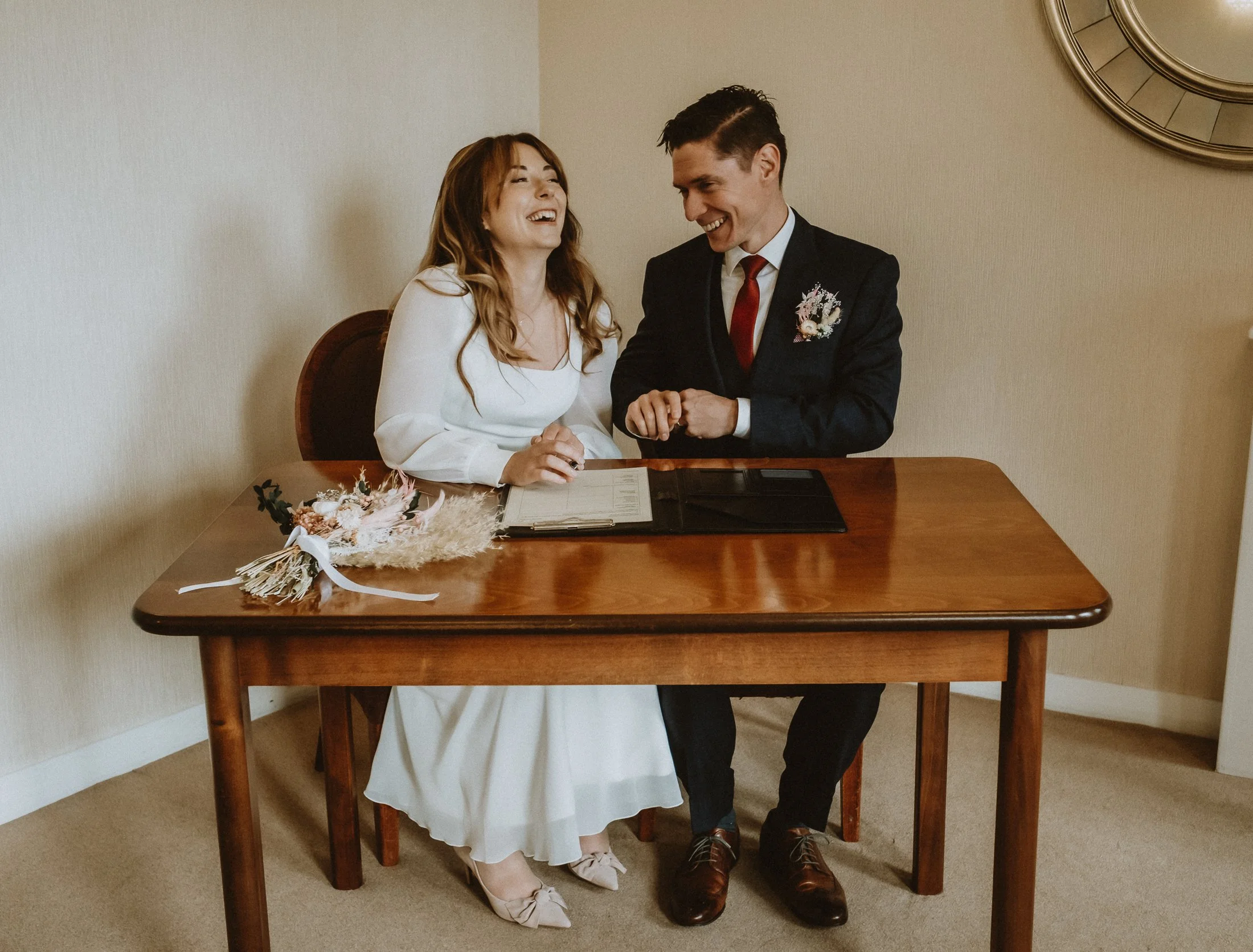 bride and groom signing the marriage schedule at Lichfield Registry Office