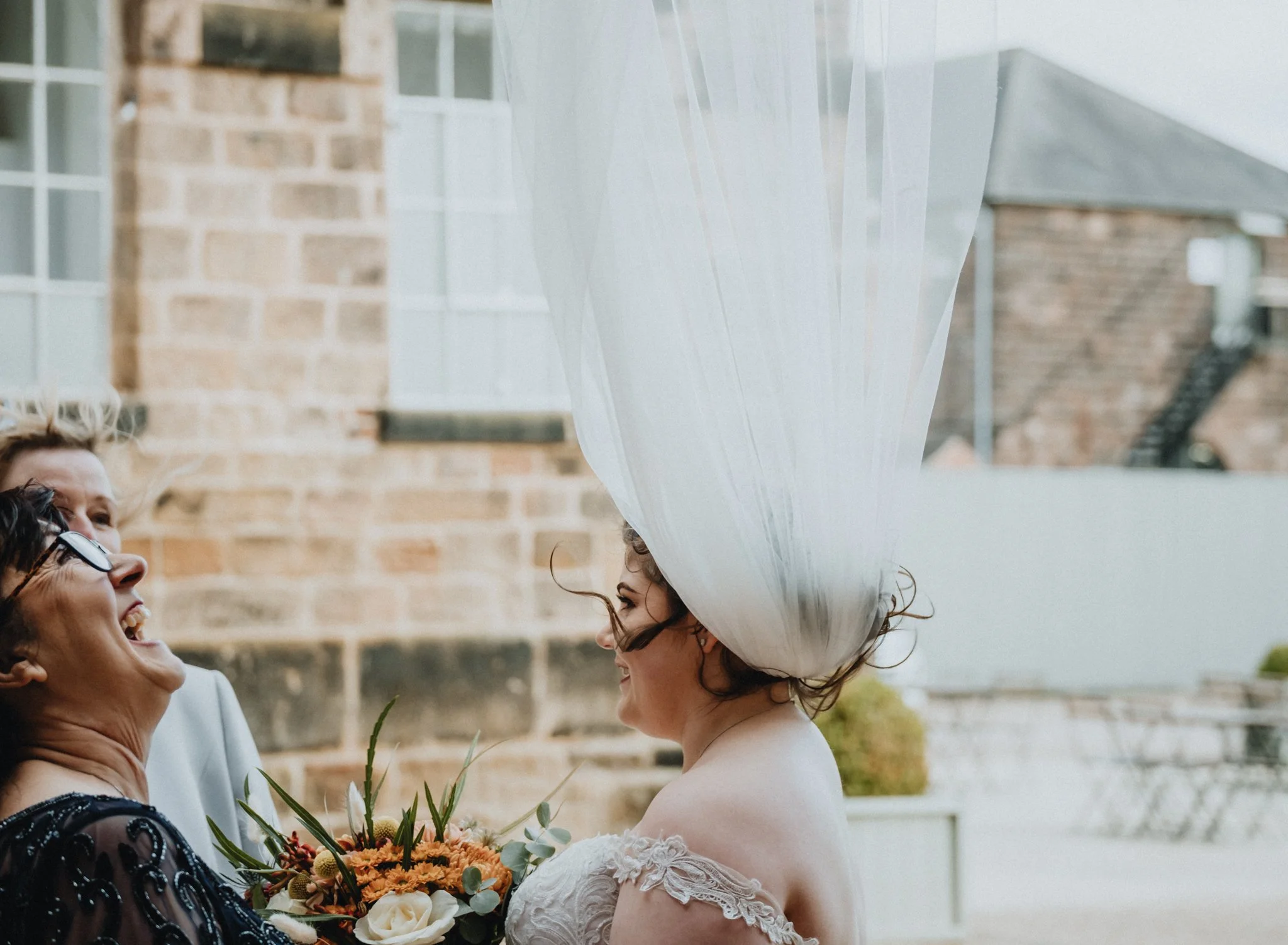 Bride's veil blowing in the wind at the west mill wedding venue in derby