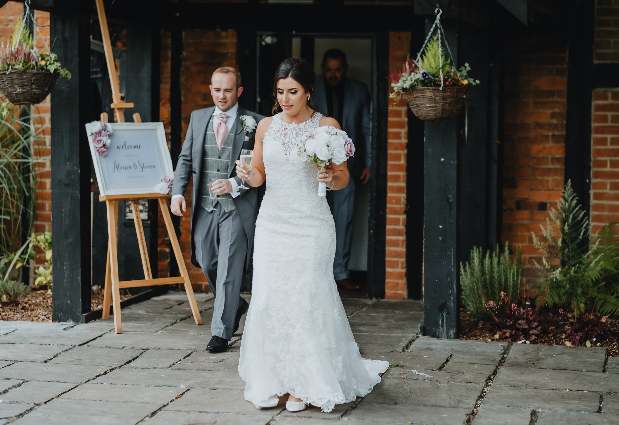 Bride and groom just exiting the ceremony room with prosecco glasses