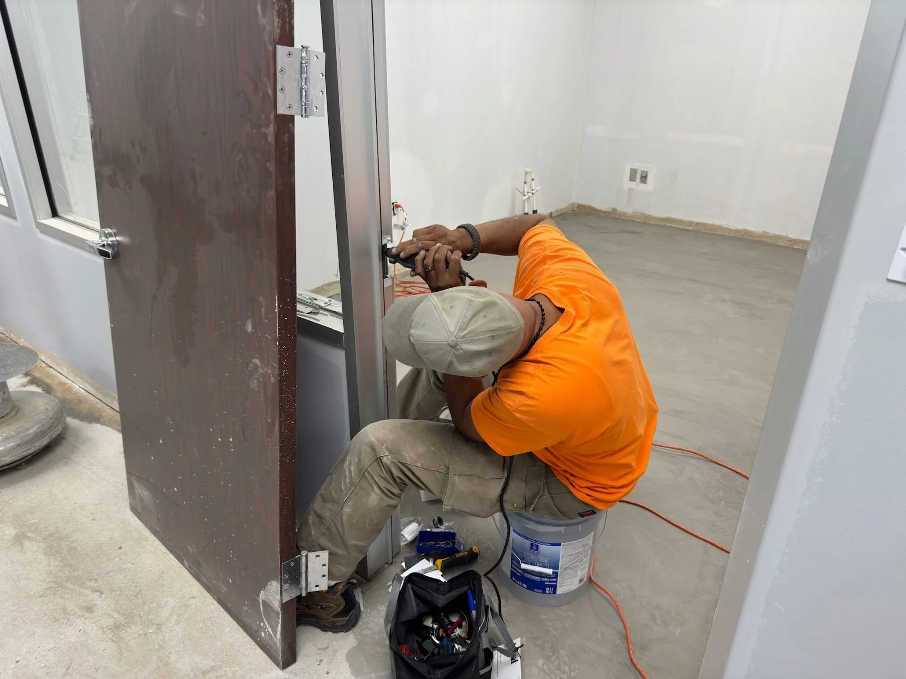 BBS technician wiring a door frame during an office build-out