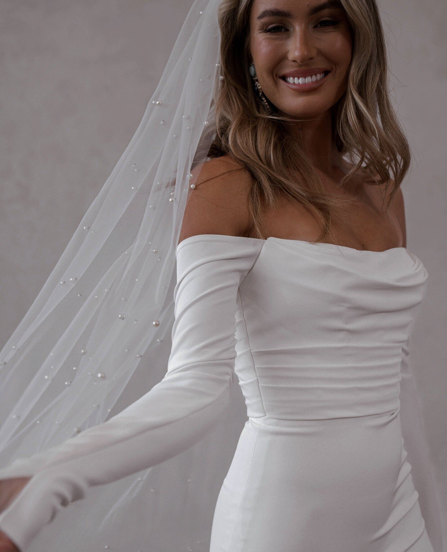 W I N T E R by MWL ✨ Our newest arrival features long off-the-shoulder sleeves, a flattering ruched bodice, and a gorgeous long train - perfect for the modern bride looking for timeless elegance.⁠
⁠
#moondancebridal #MWLWinter #madewithlove #MWLbride