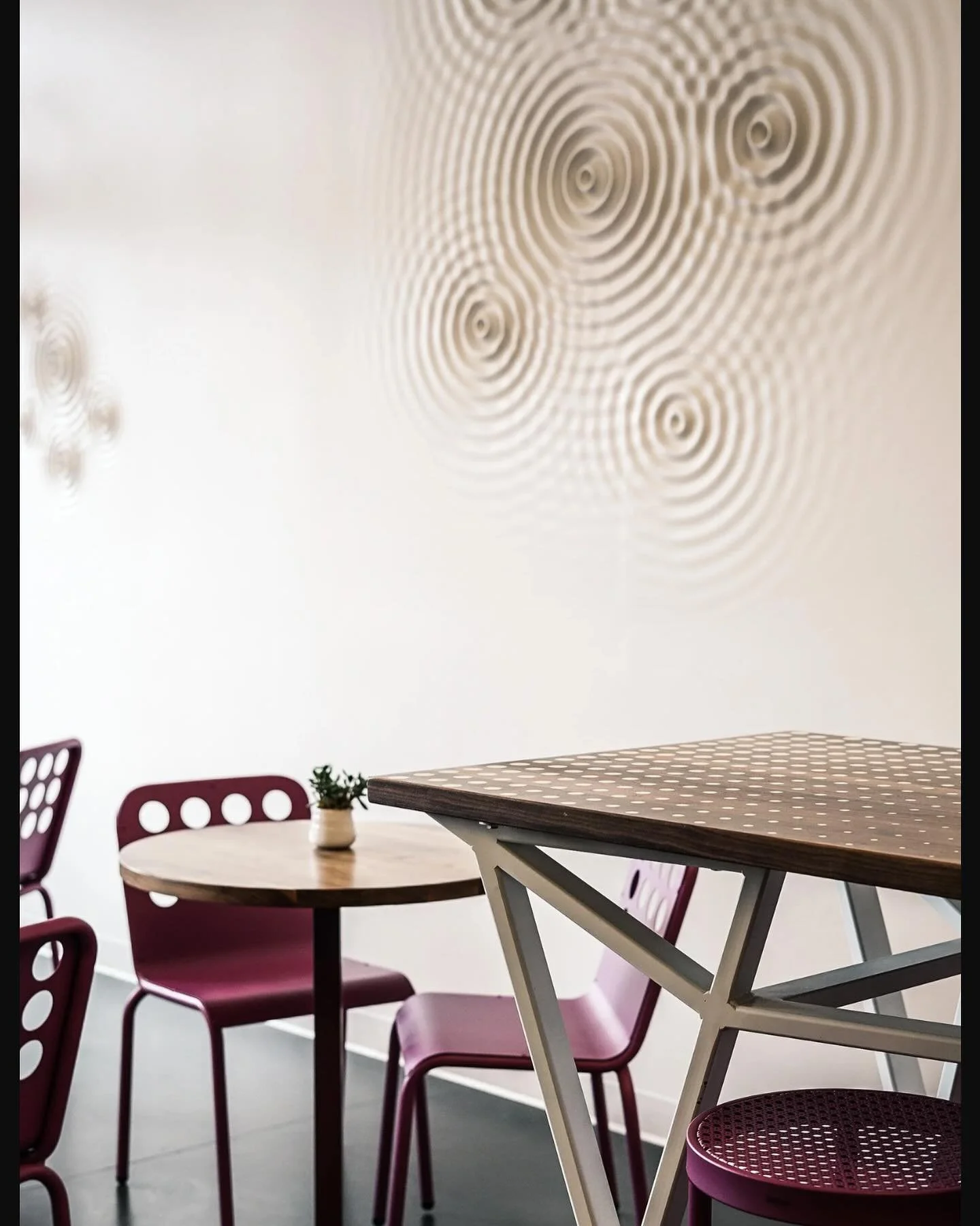 Throwing it back to Corner Beet in Cherry Creek.
Custom tables, shelving, and a statement wall feature where fuchsia grape meets walnut &mdash; and yes, it really looks that good. This project let us lean into 3D CNC machining to add precise, custom 