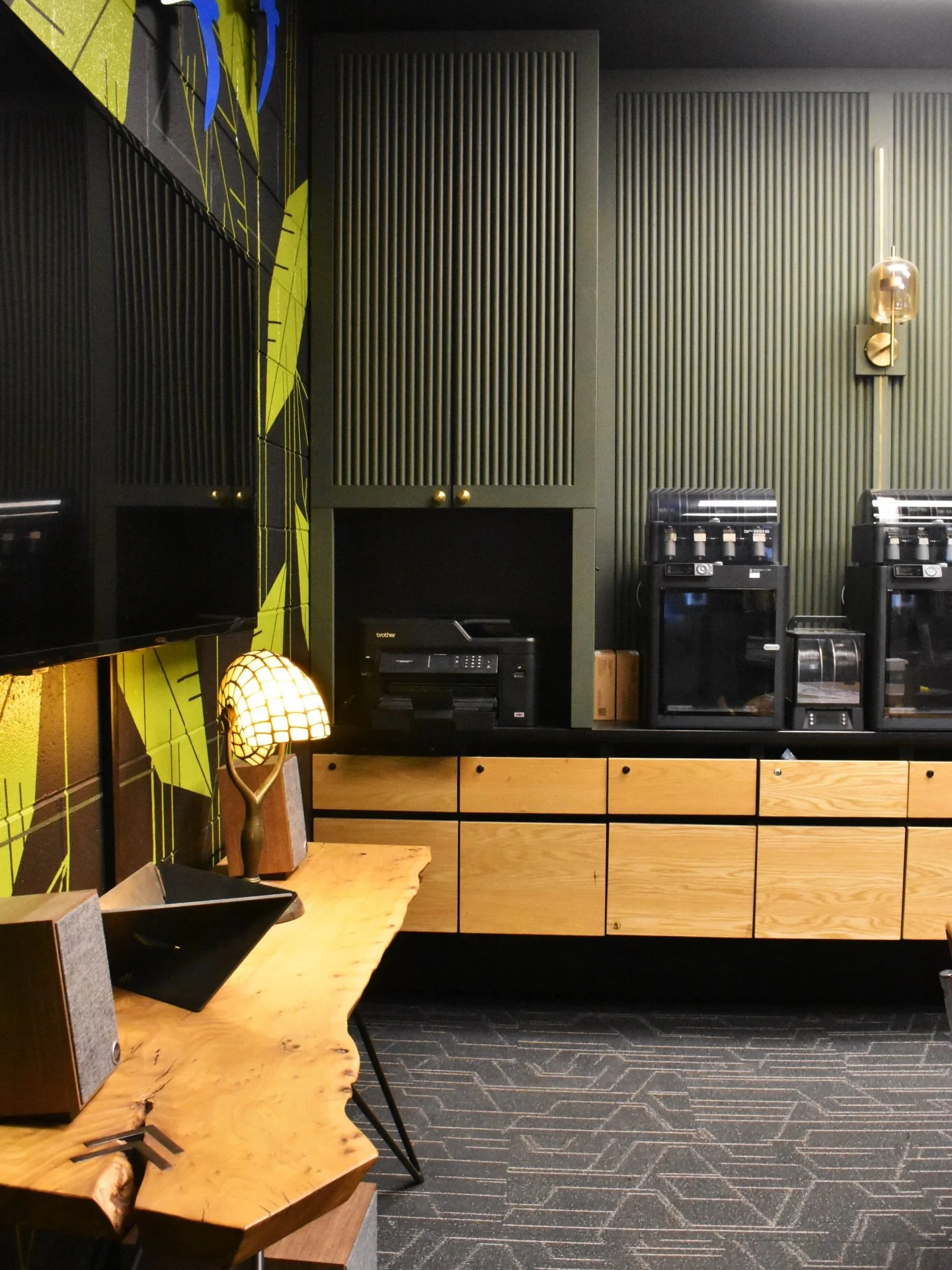Welcome to our office.
Tambour paneling, custom drawers, and steel shelving built in-house, finished with a hand-painted mural of leaves and birds that brings a little life into the studio.

Artist: @sandrafettingis 

#custommillwork #oﬃcedesign #den