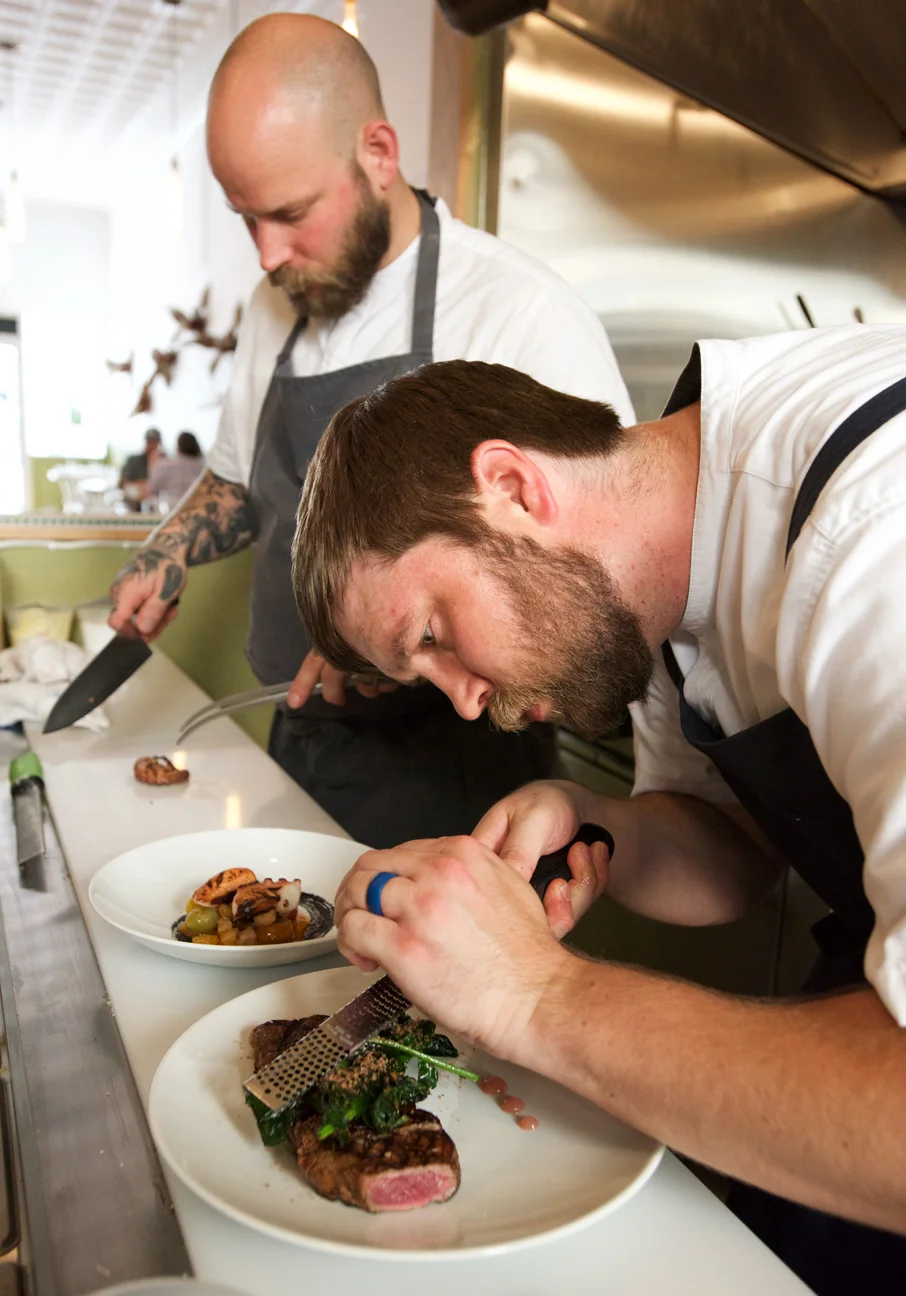 Chris and Russ work in the kitchen. Photo by Jeff Scott .