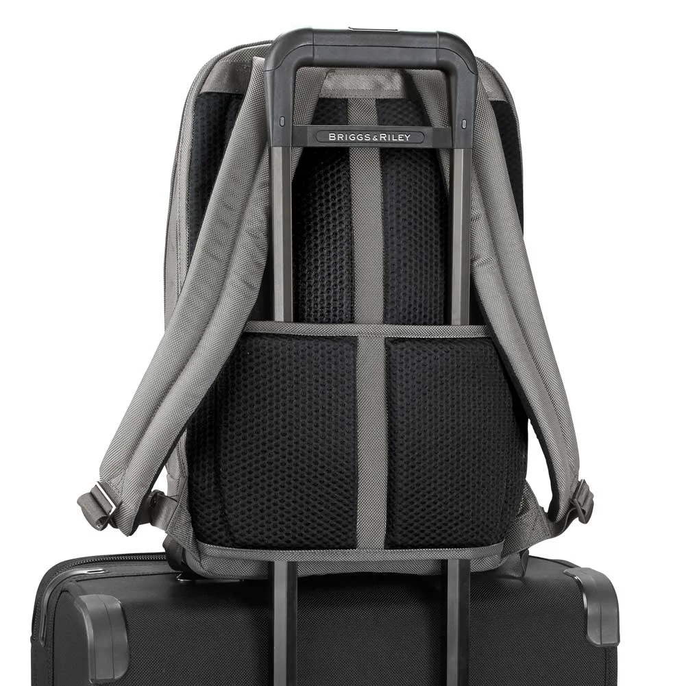grey backpack attached to outsider handle of rolling bag