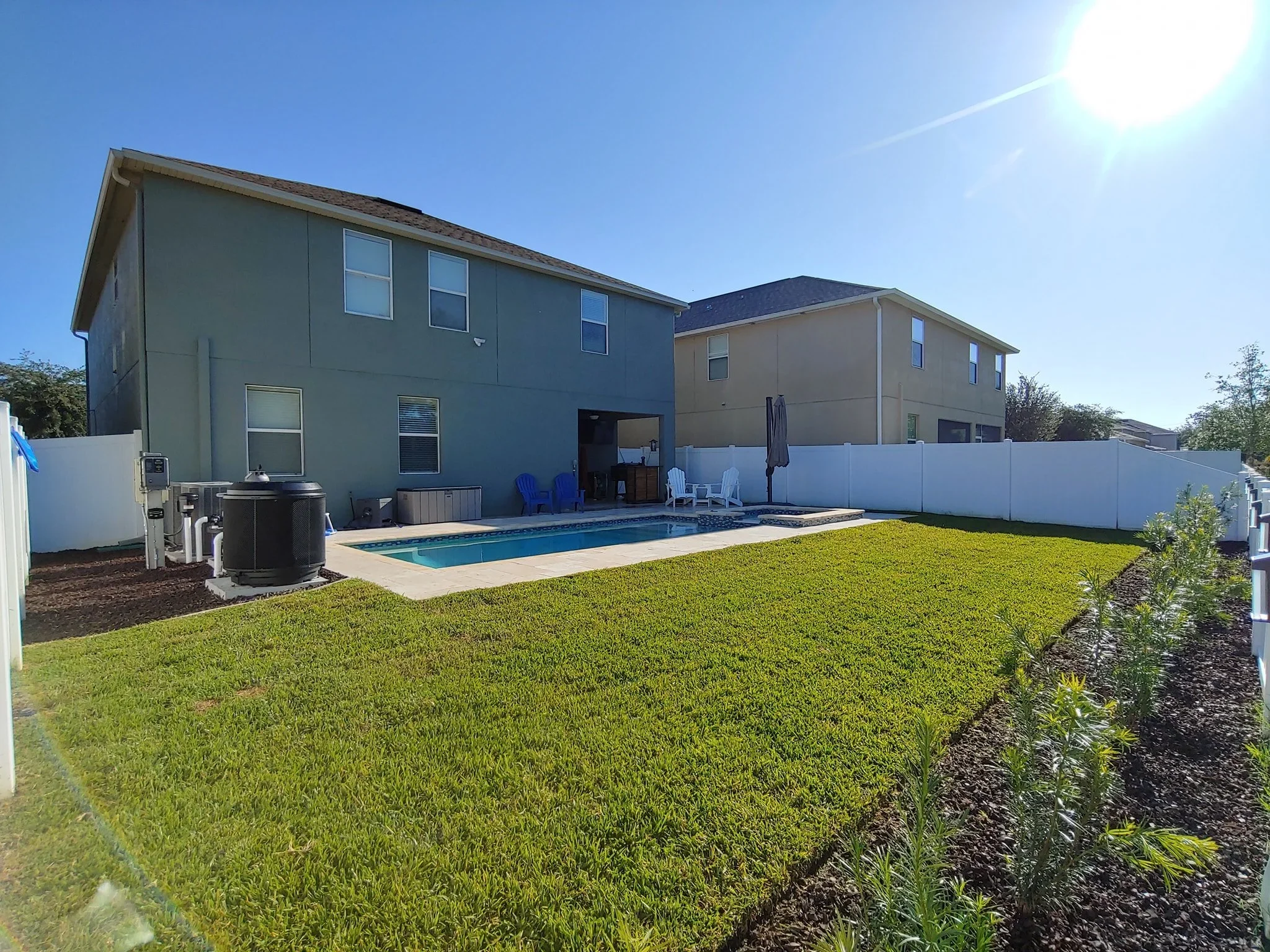 rlc-backyard-lawn-beside-a-swimming-pool-with-a-planted.webp