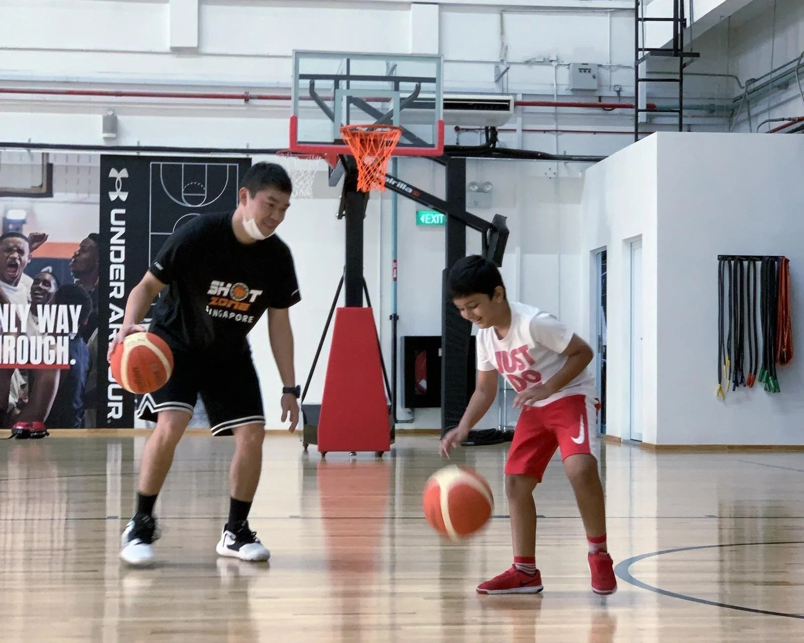 Coach Derick challenging his trainee to a dribbling showdown. 