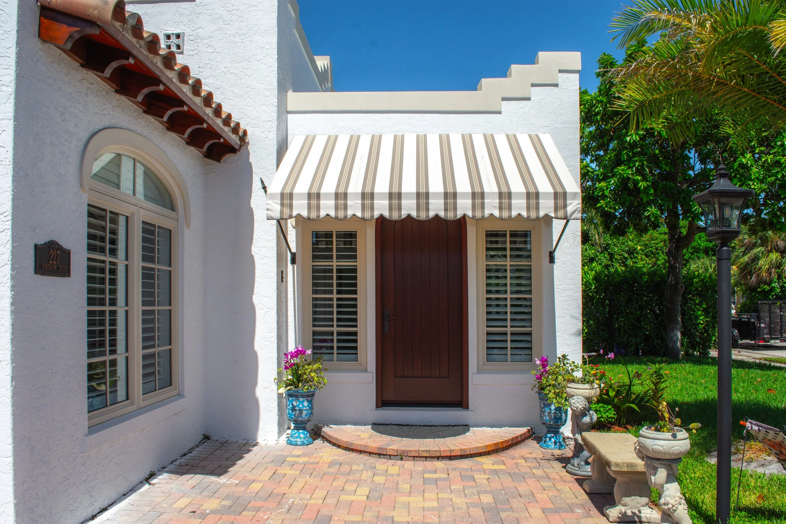 Outdoor view of the 227 Fordham residence highlighting the exterior architecture, entry area, and landscaped surroundings.