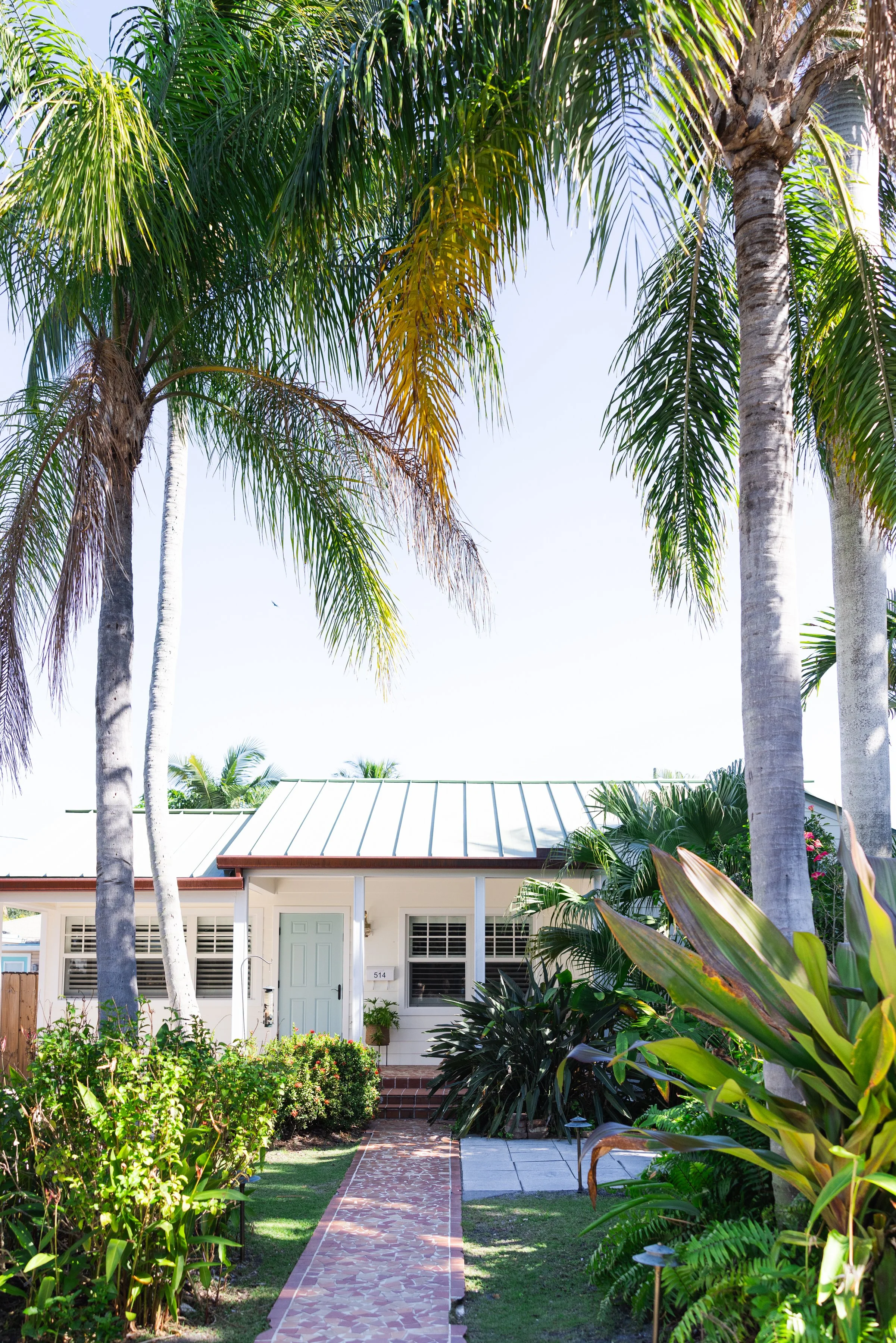 Ocean Breeze property exterior with coastal-style architecture, landscaped surroundings, and bright outdoor curb appeal.