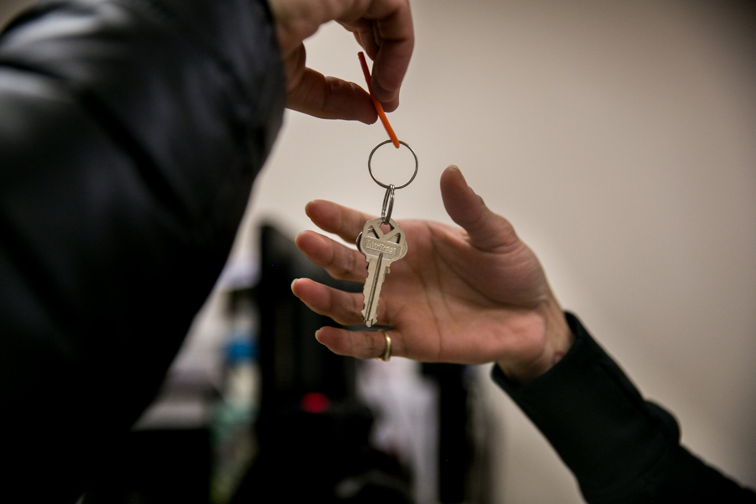  Landlord Israel M. Samet hands Madelyn Brito keys to her new apartment at the city's Human Resources Administration offices on East 16th Street in New York, New York. This set of keys later turned out to be the wrong set, keeping Brito waiting on th