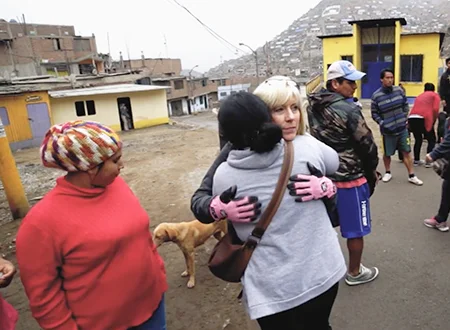 Linda greets a few of the women from Santa Rosita as they prepare for a day of ministry. 