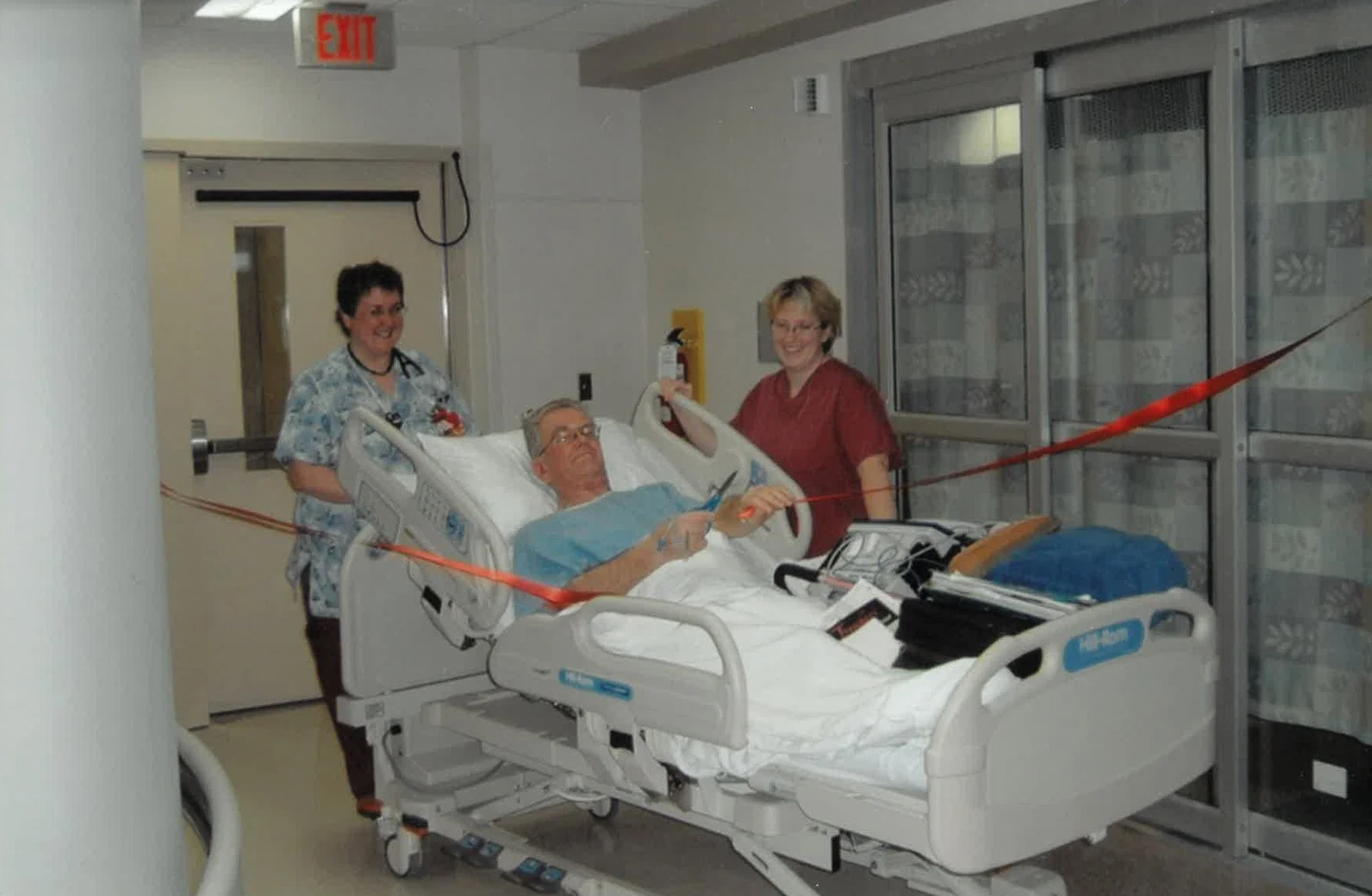 Photograph of the first patient at Queensway Carleton Hospital’s new ICU participating in the ribbon-cutting ceremony. This moment symbolizes the hospital’s dedication to patient-centered care, compassion, and teamwork.