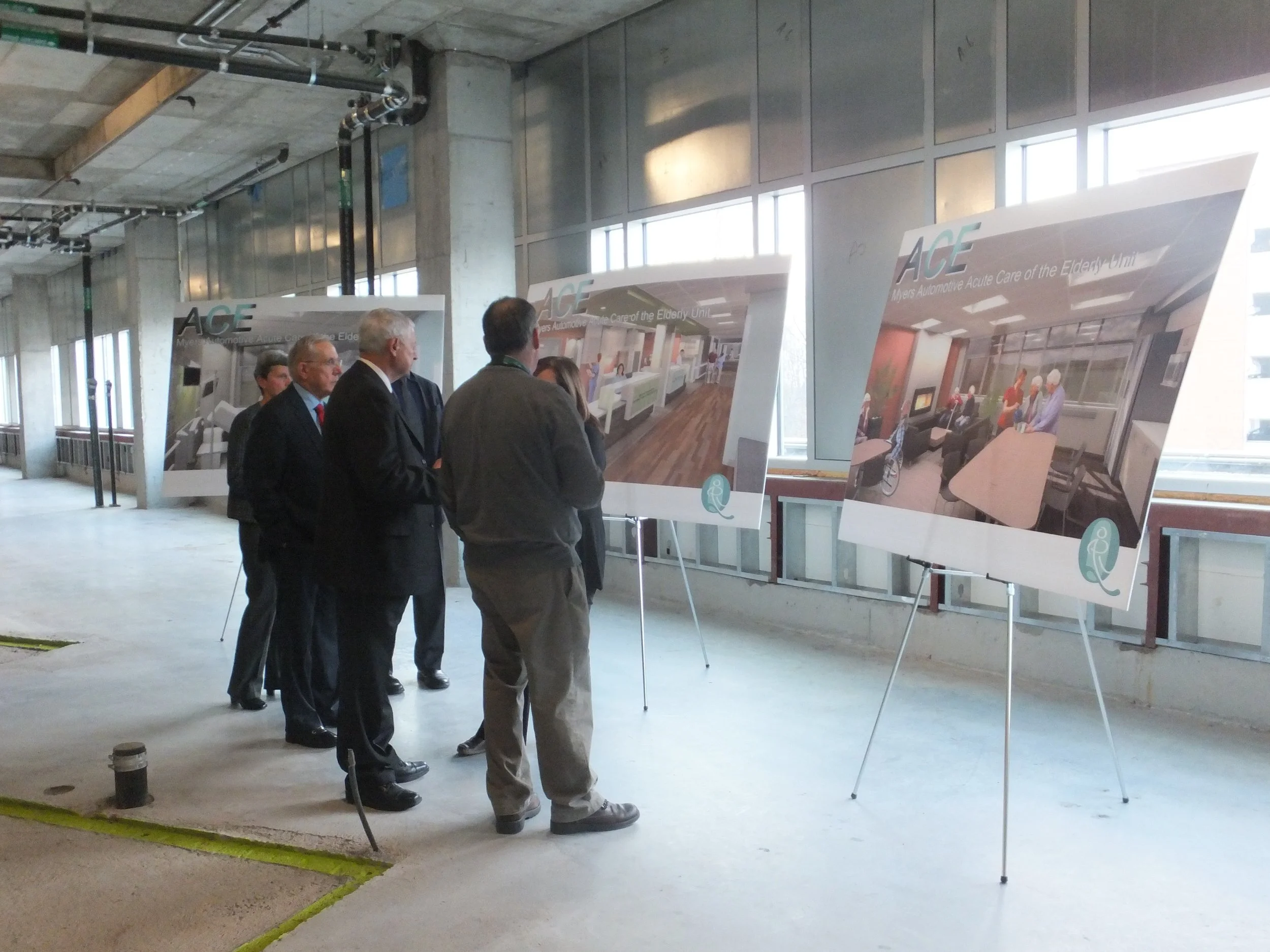 Healthcare staff and planners looking at design boards for the Acute Care of the Elderly Unit.