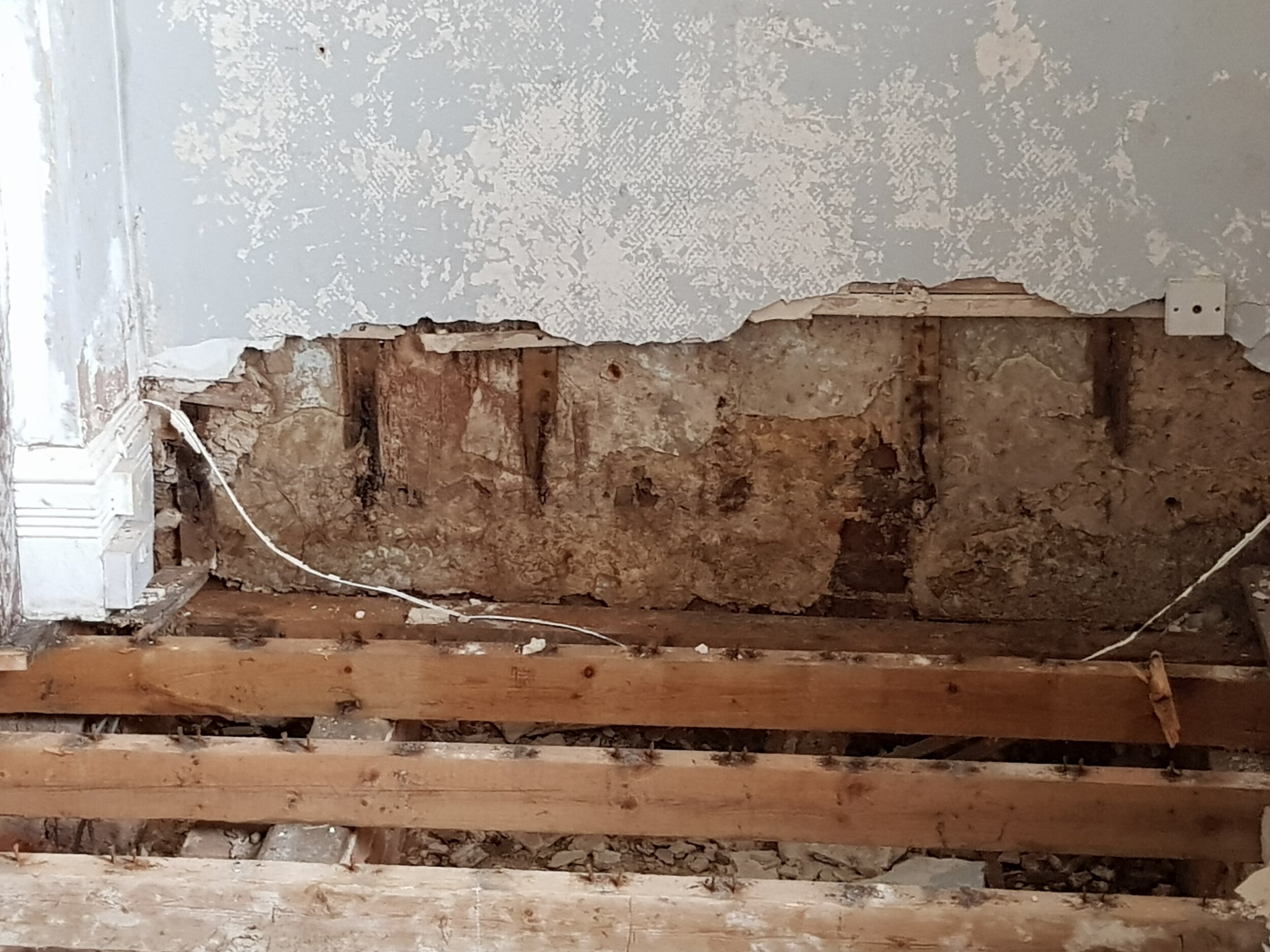 C W Johnson Limited Chartered Surveyors - Dampness in plaster hacked off