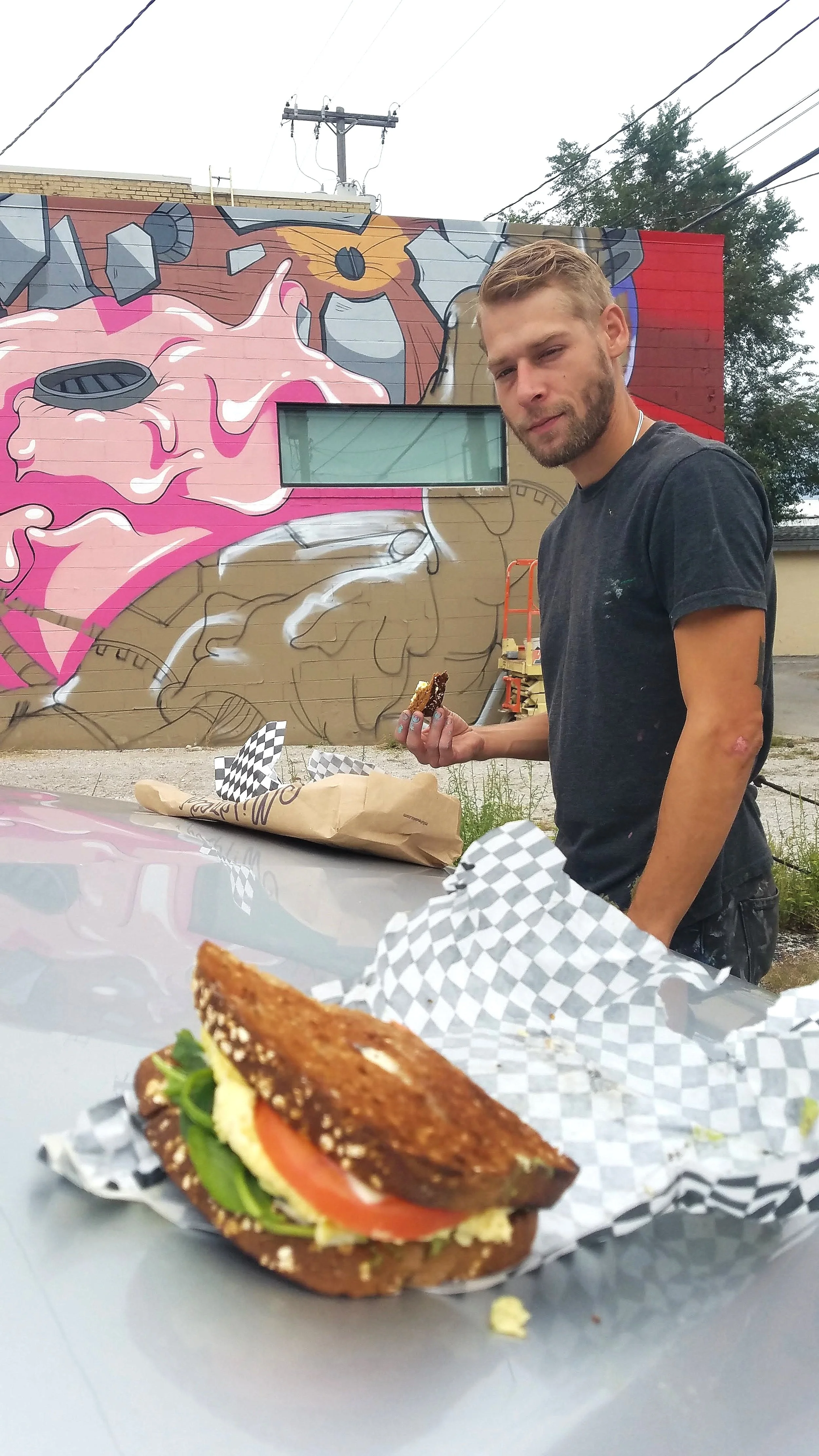 Eating Delicious Breakfast Sandwiches Donated to the Festival by Mildred’s