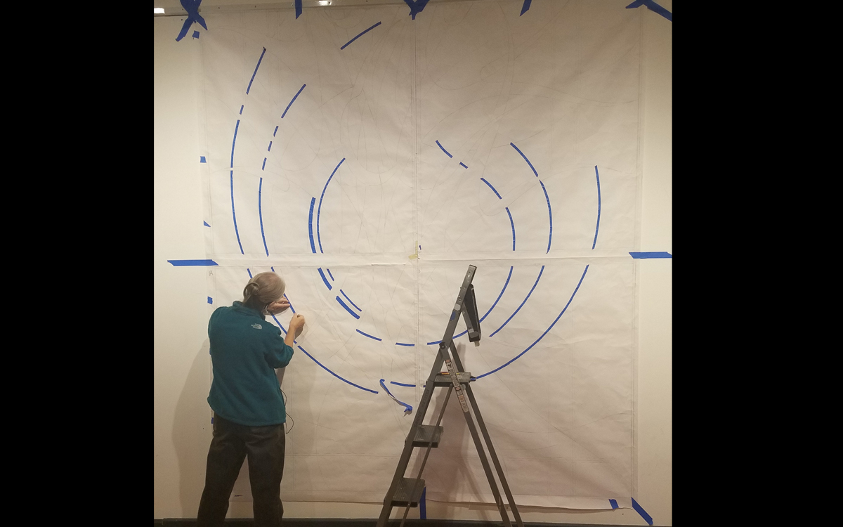 Cindy works on the full-scale drawing.