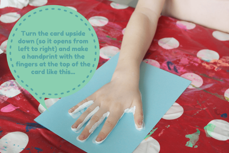 Turn-the-card-upside-down-so-it-opens-from-left-to-right-and-make-a-handprint-with-the-fingers-at-the-top-of-the-card-like-this....png