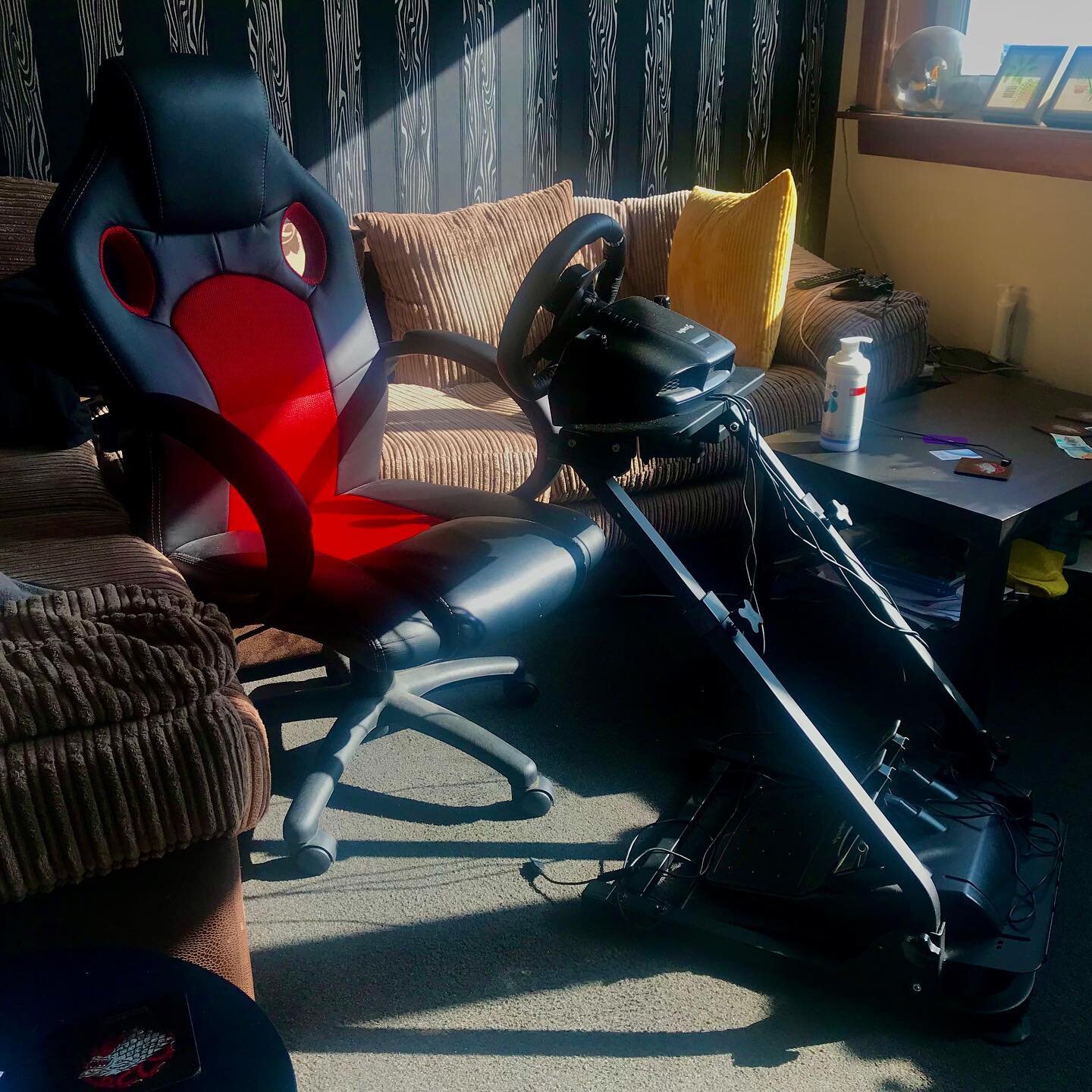 I&rsquo;m basically a Sim Racer now. 
Only the best, most professional setup with my old office chair wedged against the sofa to stop it from rolling back whenever I press on the brakes. 
Pretty sure Lewis Hamilton has the same rig in his living-room
