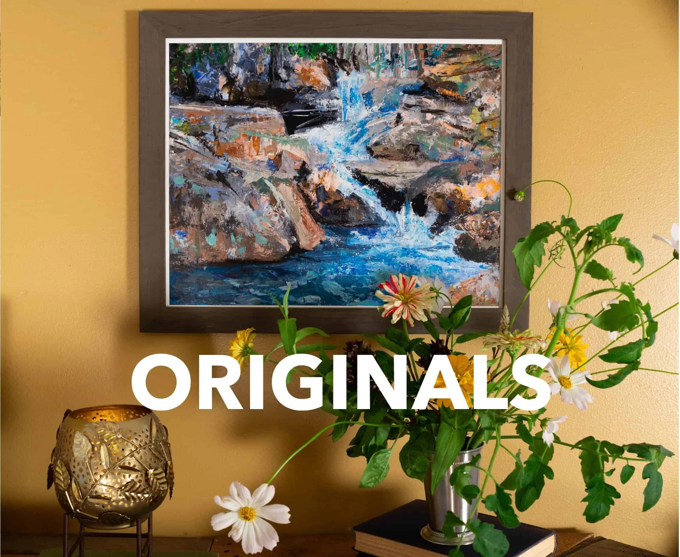 Original waterfall painting framed and hanging on a wall with a floral arrangement in the foreground. Text on image reads "Originals."