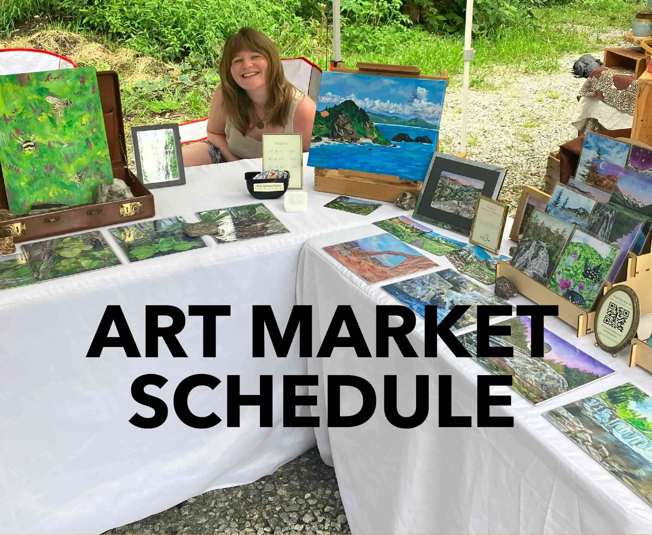Artist sitting at a market table with an arrangement of original artwork and fine art prints displayed. Text on image reads "Art Market Schedule."