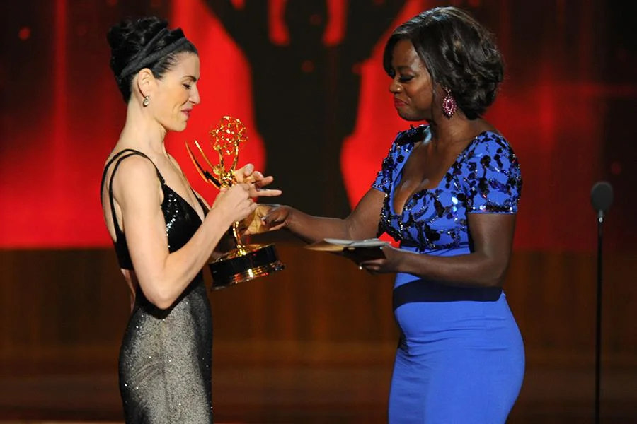 Julianna Margulies (l) of The Good Wife accepts an award from Viola Davis at the 66th Emmy Awards. Invision/AP