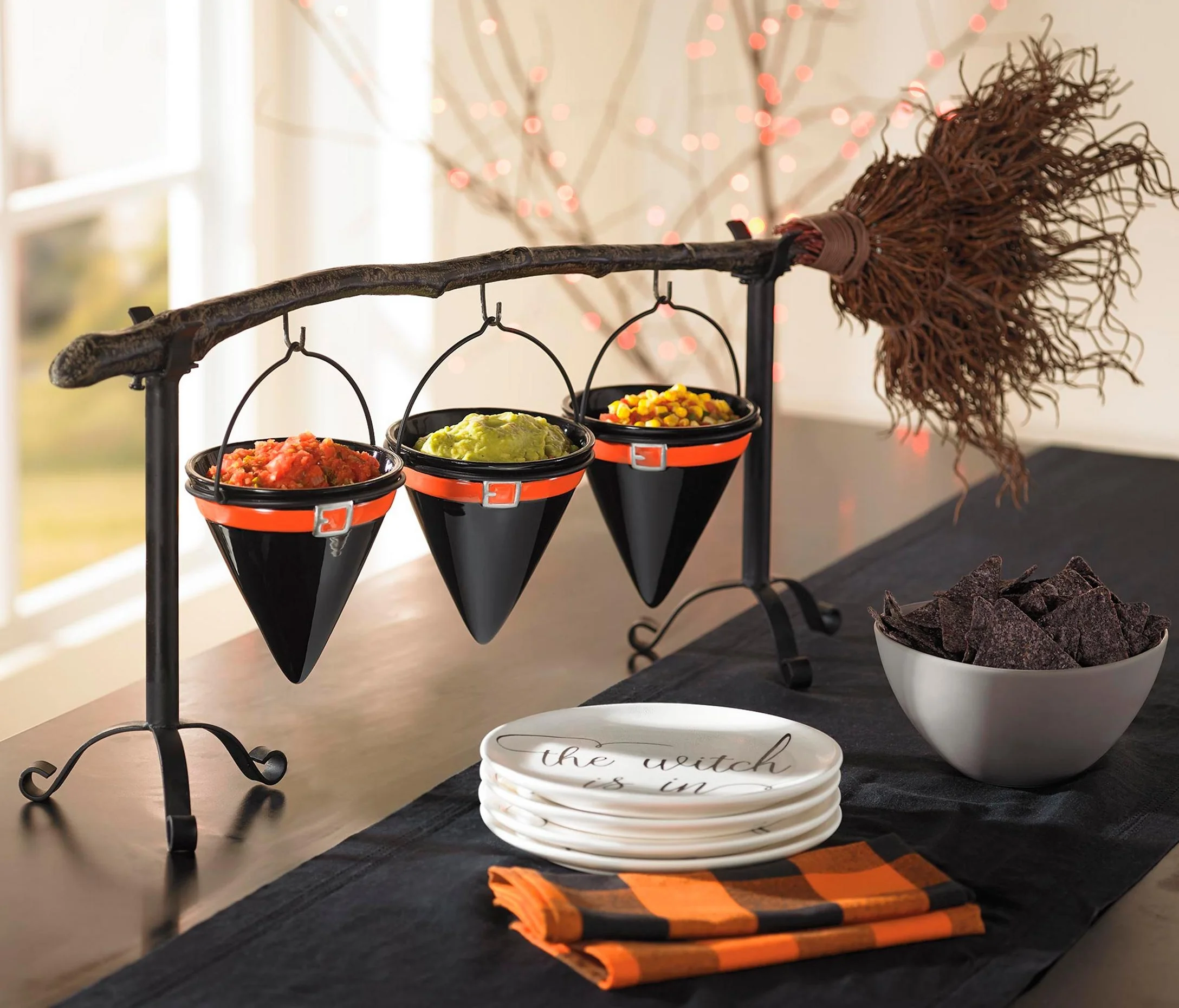  Broomstick Snack Bowl Stand. This versatile piece comes with two components -- three ceramic hanging witch hats to store candy and a hanging chalkboard sign.  Image from grandinroad.com.  