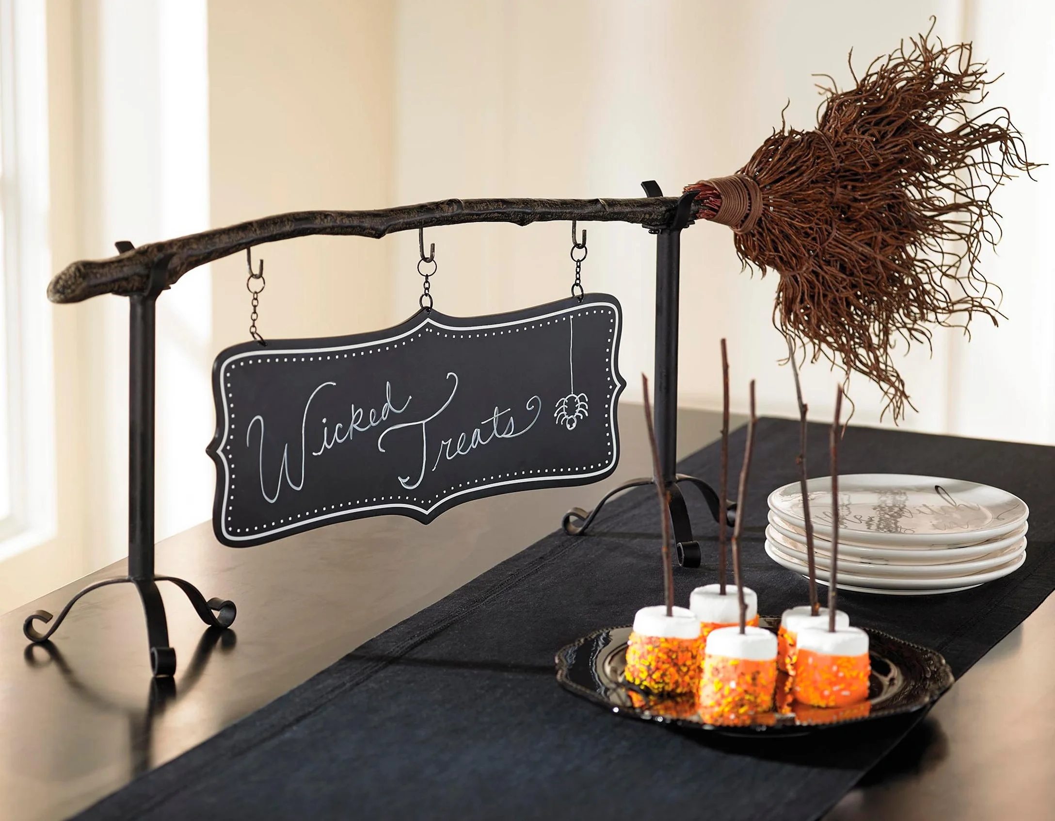  The Broomstick Snack Bowl Stand - shown with hanging chalkboard sign.  Image from grandinroad.com.  