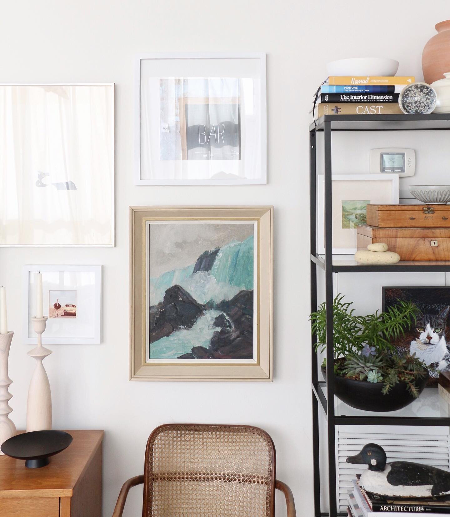 My mini art wall.. the tv is just to the left and of course, I didn&rsquo;t want to stare at the condo air return and thermostat on the same wall to the right. I added dimension to the wall with an open etagere and disguised this eyesore 👀 air retur