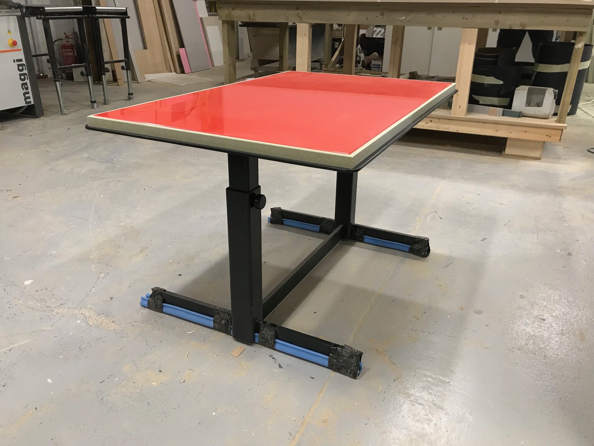 Gennaro table - low position with painted glass and powder coated legs.
