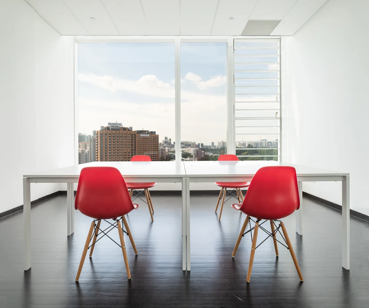 An office with a view. We have placed 4 tables at the end of the office, in a configuration of 2 + 2 i.e. stacked together. One can fit 9 such tables and chairs comfortably.