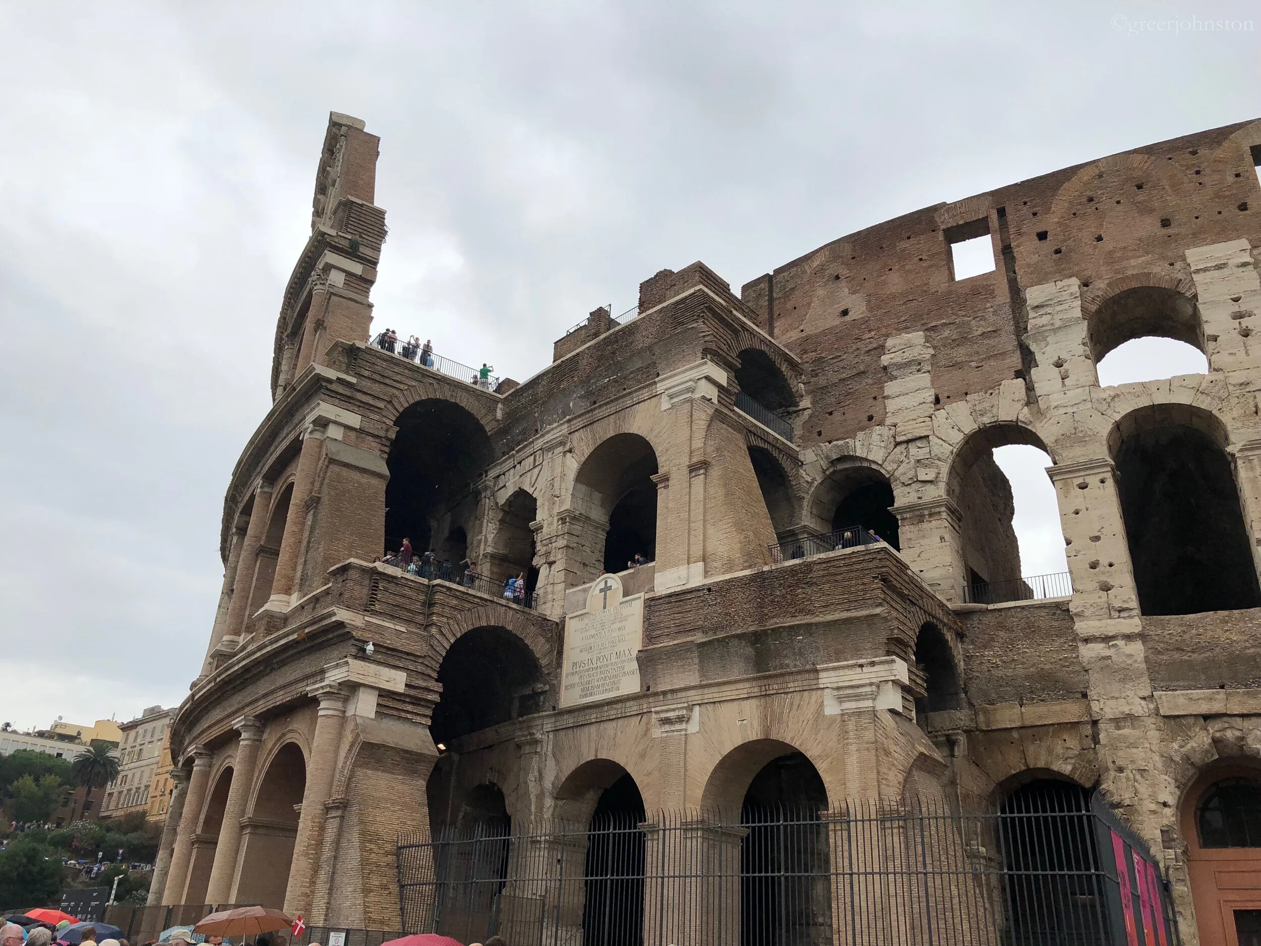 The stratification of the walls of the Colosseum offers a glimpse inside. Also, the entrance is located just to the right of where this occurs.