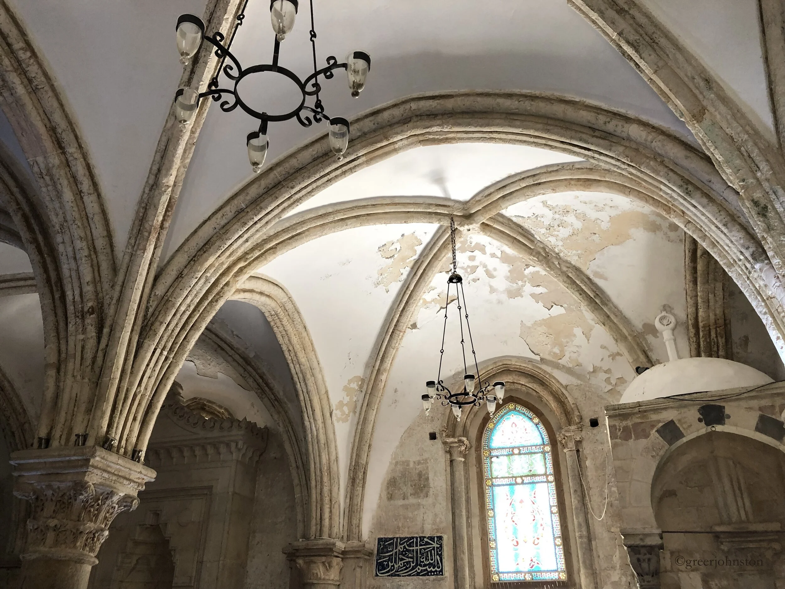 Inside, the Cenacle appears much like a former mosque would, with Arabic calligraphy and the mihrab in the lower=left hand corner of the photo
