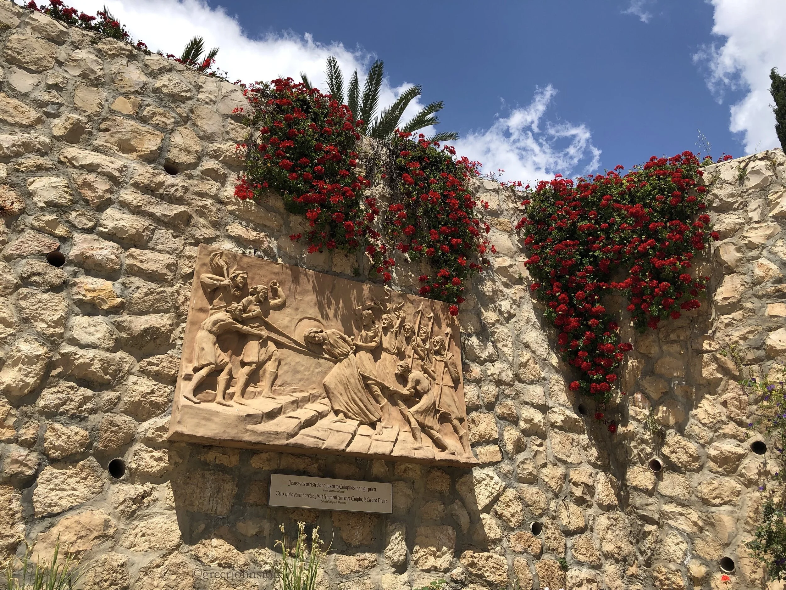 Flowers and scenes from the Gospel in the garden of St. Peter in Gallicantu