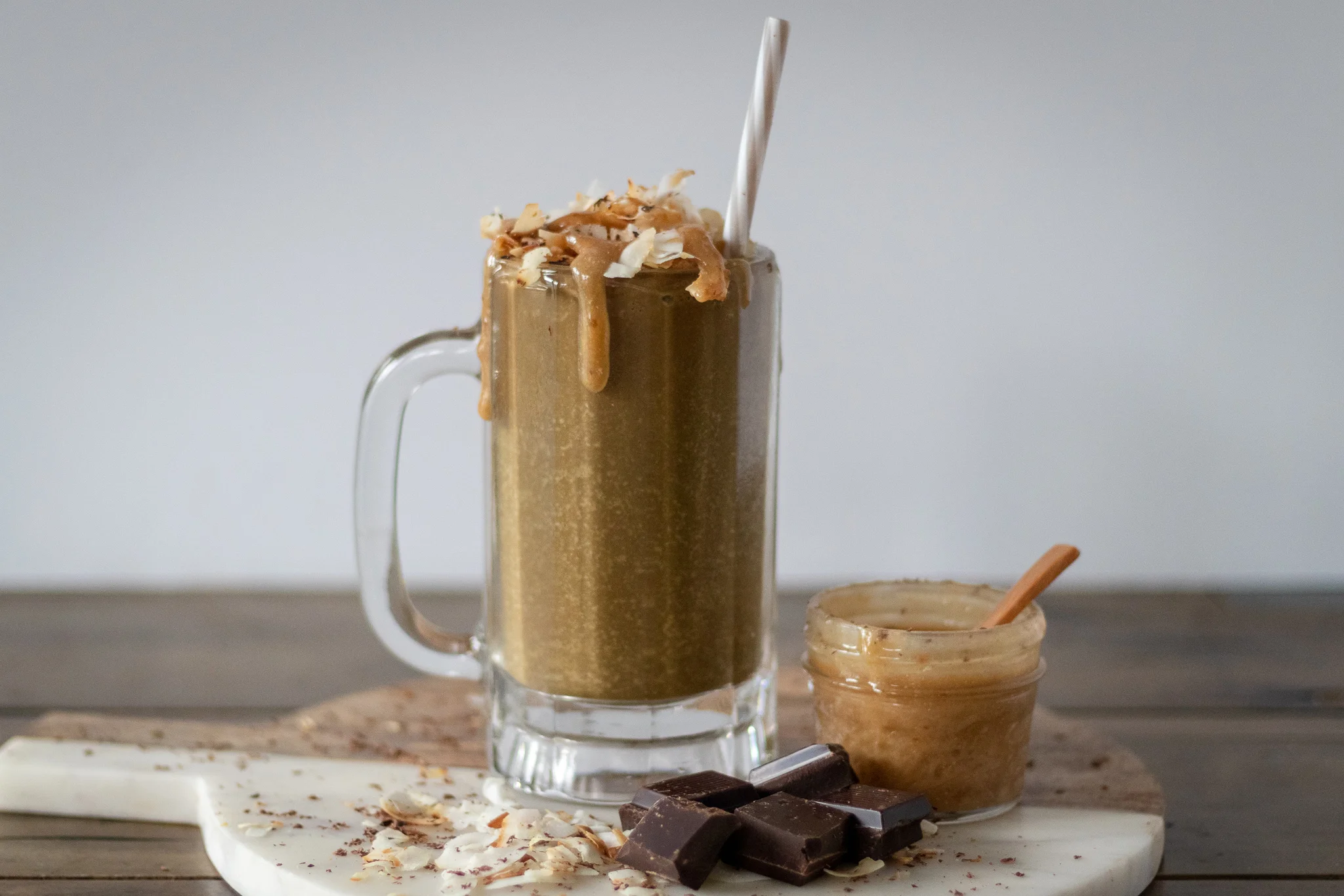 Raise your hand if you have ever had a Samoa Girl Scout cookie. If you have, you probably know what all the hype is about. Gooey Caramel, Chocolate, and toasted coconut perfection. Sadly, Samoas are not one of the Girls Scout’s vegan cookie offerings. No worries, Y’all! I think I have just the thing for you! This smoothie is far healthier than a cookie, but taste just as good in my opinion. It has it all!! Chocolate, coconut, and caramel all blended up creamy smooth and so delicious. What it doesn't have is refined sugar, and 100% less guilt than a cookie! Also you can have this for breakfast and not spend your day drowning in regret! WIN WIN WIN! Oh, and the caramel sauce is raw and you will probably find 100 different ways to use it, too! So don’t worry the leftovers, you will thank me later when you are dipping an apple into it ,and again not feeling one ounce of remorse! So blend yourself up a Vegan Samoa Smoothie and walk right past that cookie table those adorable girls have set up in front of your local grocery store, never looking back (OR run back and grab a box of the some of their vegan cookies because after all they are adorable, and its super hard to say no!)