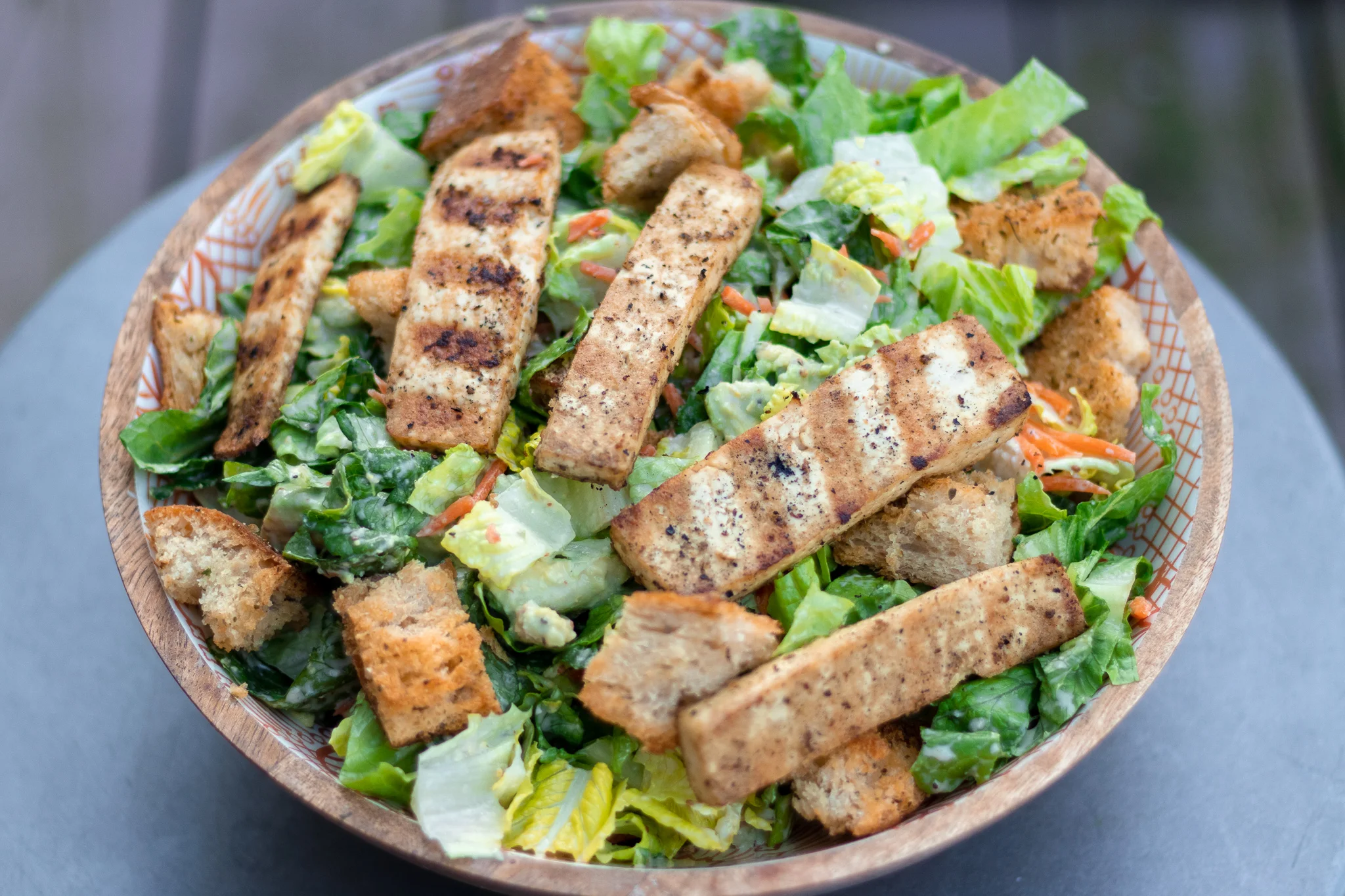 I have tried a ton of vegan caesar salad recipes, and dressings over the years, and until now none have been a winner. So when recently I was making a caesar salad, and contemplating the protein I would add, I decided on Alabama White Sauce Grilled Tofu, and a light bulb went off. Alabama White Sauce (AWS) is a a tangy, vinegar and mayo based bbq sauce which originated it Northern Alabama at Big Robs Bar-B-Q. Our AWS is a vinegar and mayo based sauce like the original, with a little kick and has just enough tang to work as a caesar dressing substitute. AWS is a staple condiment in our house because it is delicious and versatile, and not just for bbq! So after I grilled up the tofu, it occurred to me to take the leftover sauce and turn it into the dressing for this salad . PURE JOY! It was so good that I will never attempt another “caesar” dressing recipe again. I also added some carrots and avocado to this salad because I’m adult and I can do what I want..right?? And what I want is avocado and carrots on everything, even if it's not the norm, who cares if it tastes good. So if you are searching for a super tasty, all be it nontraditional caesar salad recipe, here ya go! And my guess is if you try it, AWS will become a fridge staple for you as well.