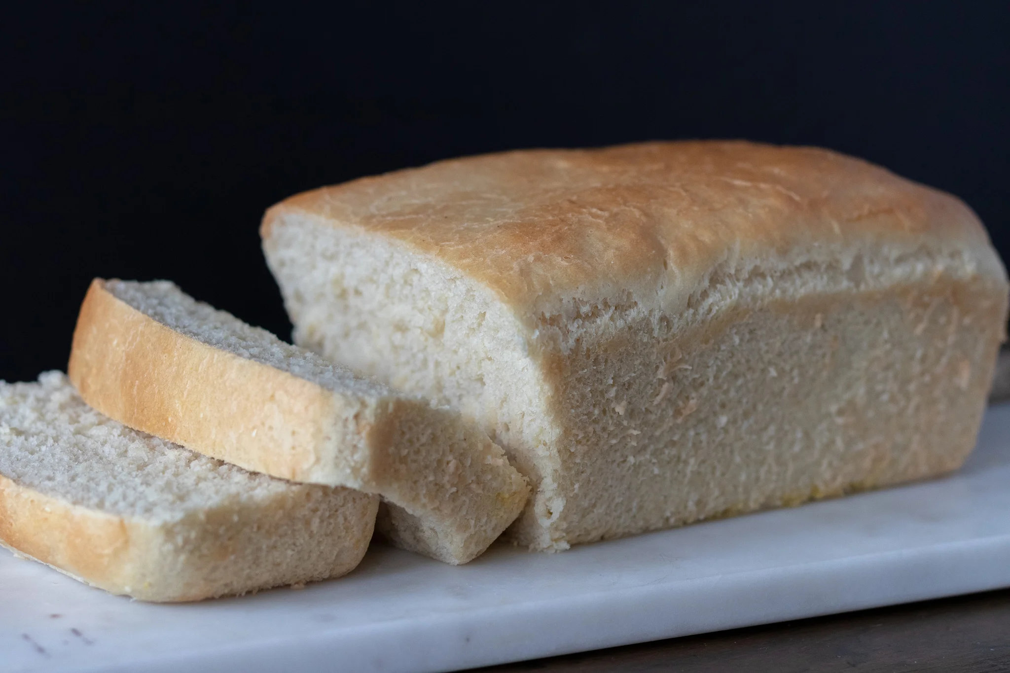 I love to smell fresh bread baking. Carbs are my weakness. I actually have a necklace that I wear often that says “carbs” with a heart engraved on it. So you can see my love for bread and all things carbs runs deep. I really, really love a nice big delicious sandwich on fresh baked bread! If you have never made loaf bread, let me tell you, you are missing out. You do not need a fancy bread machine to make easy and fresh baked bread either! Just a loaf pan and an oven. I am always amazed at just how many ingredients are in store bought bread, half of which I do not know what they are ,or how to pronounce. So I end up paying $5 or more for a loaf of vegan organic, healthier bread, which will be gone after my family of 6 make a sandwich. Homemade vegan bread is far cheaper, and much healthier than most store bought options, and its easy to make! You can easily double this recipe as well, and bake up two loaves at once if you are like us and have a lot of mouths to feed. It also freezes well so you could bake up 2 loaves,and just freeze one for later!!! So to all you other carb lovers out there, may your bread always be fresh, fluffy, and make you super happy!!