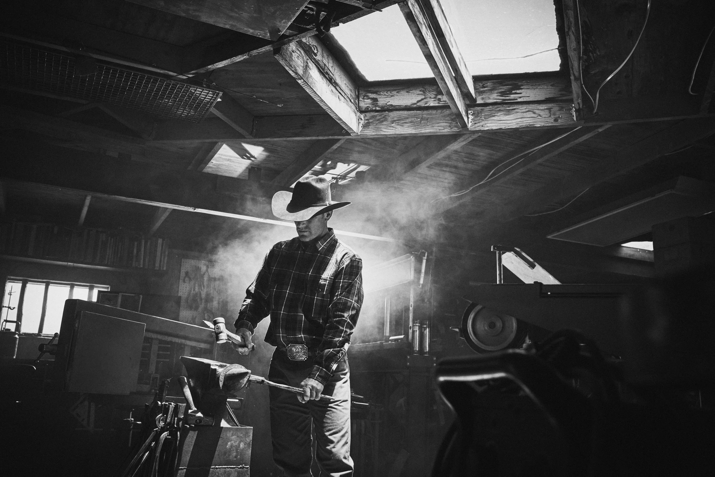 Cowboy working in blacksmith shop
