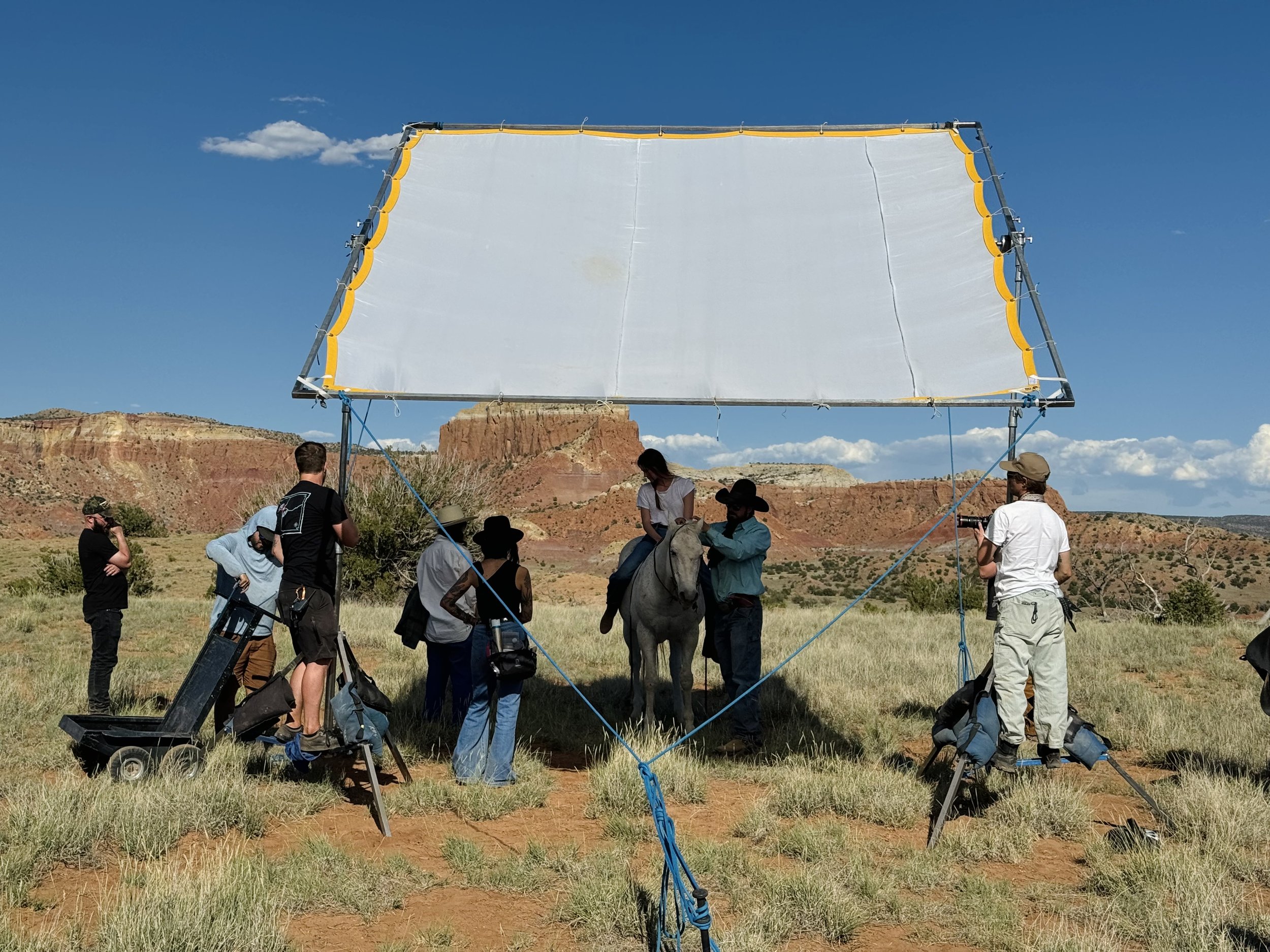 Film crew with overhead silk