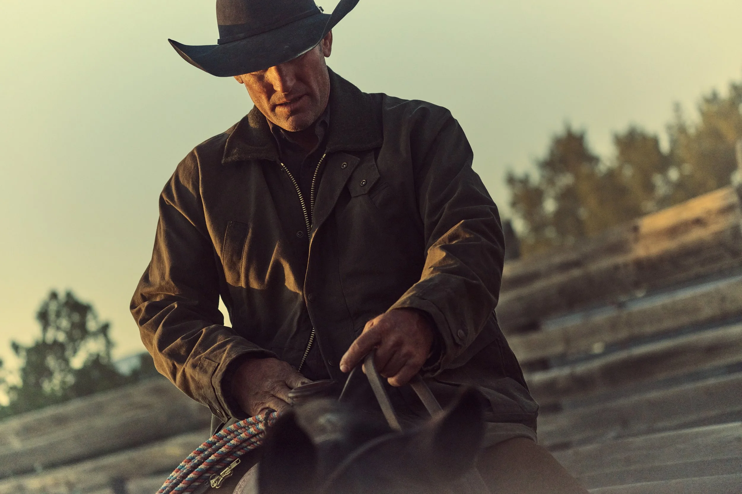 Cowboy prepping saddle