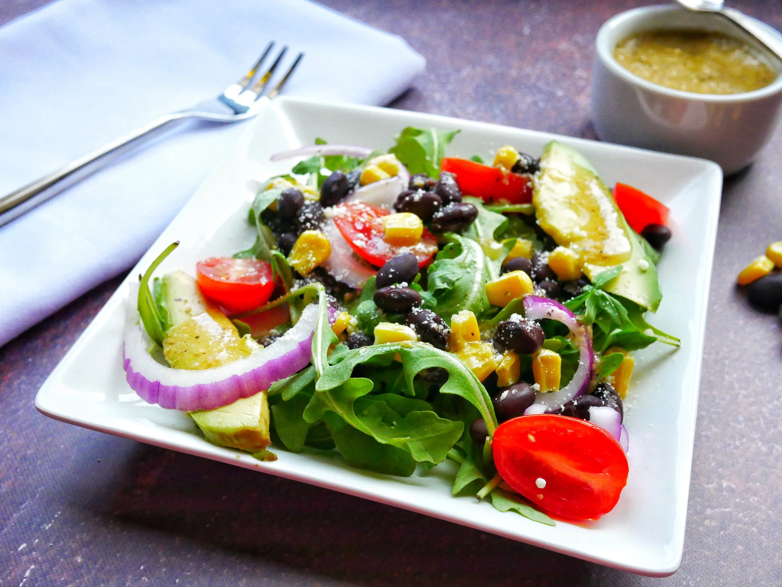 Arugula, Black Bean, Corn, and Avocado Salad with Light Caesar Dressing