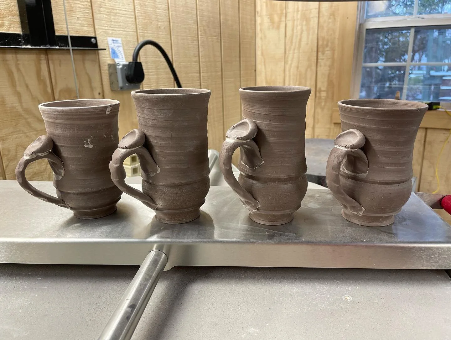 Four Mugs standing in line to be fired

#mugs #handmademug #coffee #tea #bigmug #process #clay #ceramics