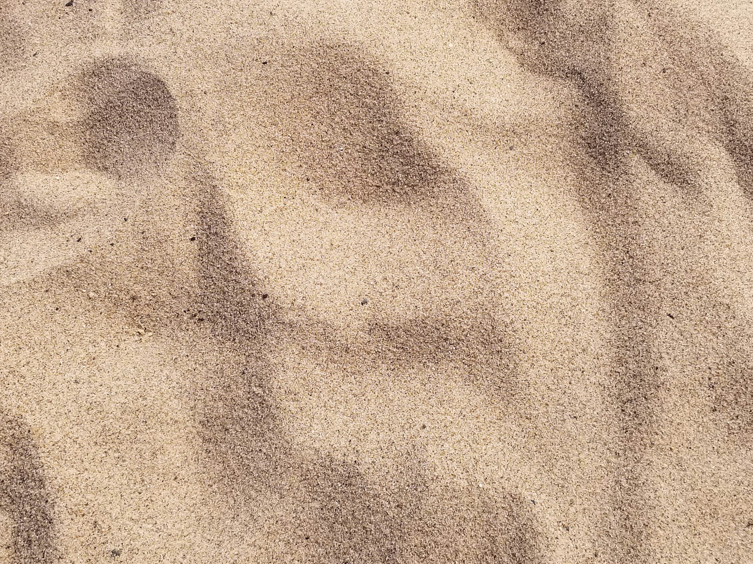 an image of beige colored sand, representing sand play and sand boxes that can be used to enhance speech and language opportunities in speech therapy or with parents who have been coached by a speech therapist for their child working on speech goals